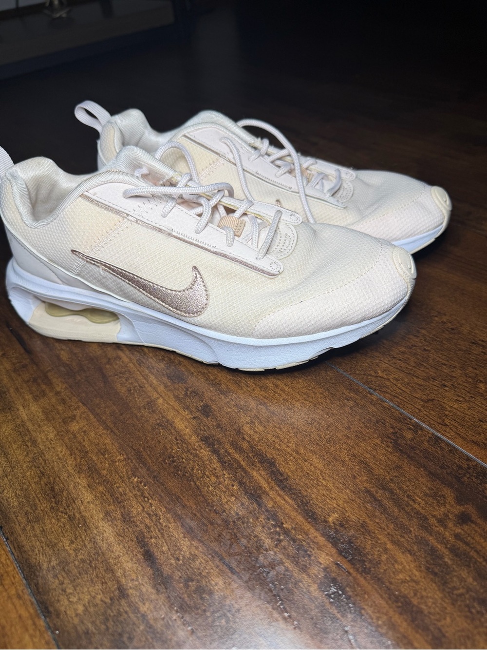 Nike women’s Light Beige Sneakers with Gold Swoosh